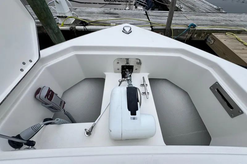 Slide: The Image of 2025 Sailfish 276 DC boat with dual Mercury engines at sunset on calm water. - 10