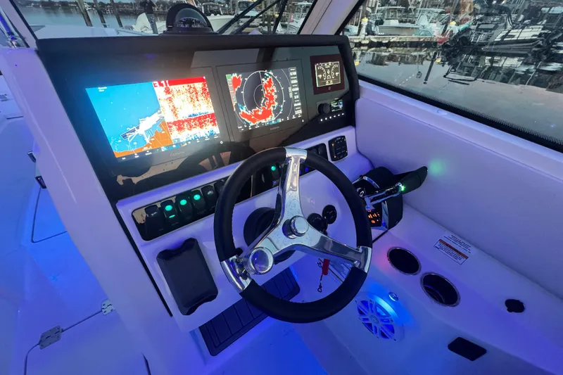 Slide: The Image of 2025 Sailfish 276 DC boat dashboard with advanced navigation displays and controls. - 6