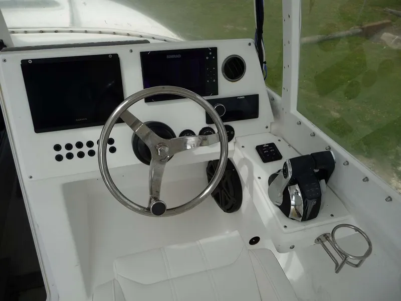 Slide: The Image of 1985 Wellcraft Scarab 34 boat cockpit with steering wheel and control panel. - 16