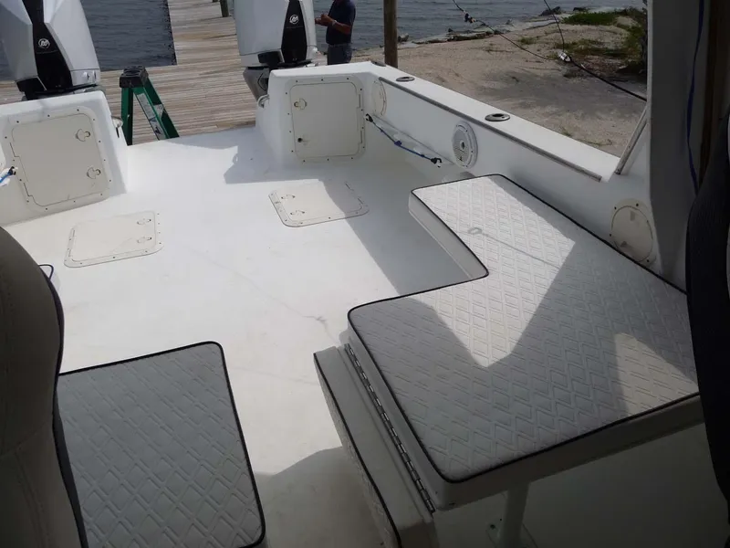 Slide: The Image of 1985 Wellcraft Scarab 34 boat interior with cushioned seating and outboard motors. - 18