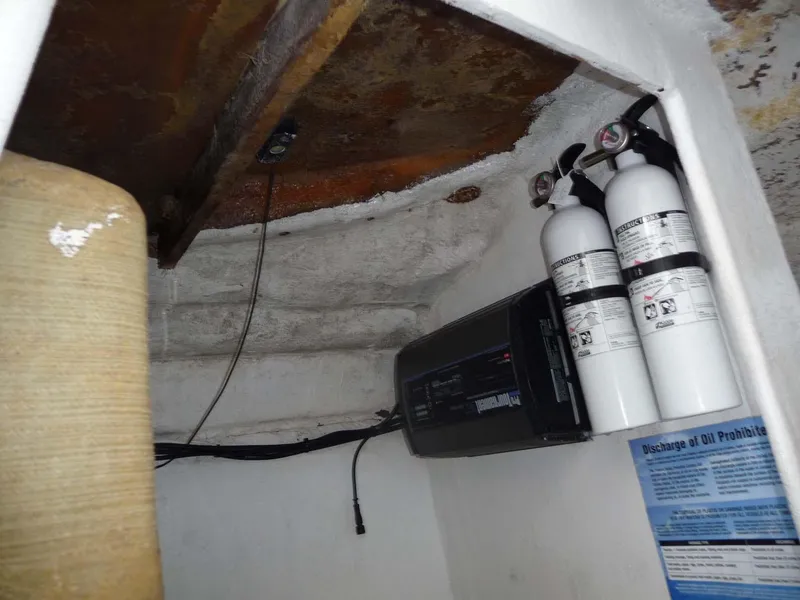 Slide: The Image of 1985 Wellcraft Scarab 34 interior with fire extinguishers and equipment. - 20