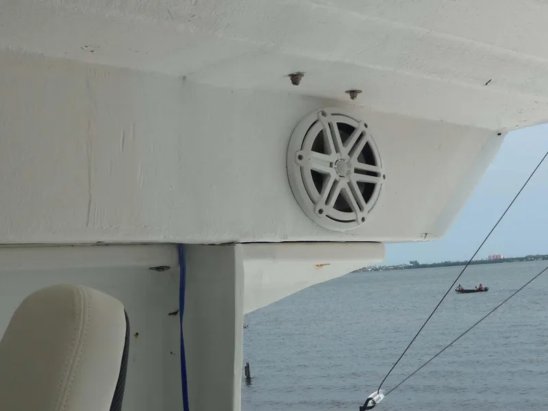 Slide: The Image of 1985 Wellcraft Scarab 34 boat interior with speaker, overlooking calm waters. - 21