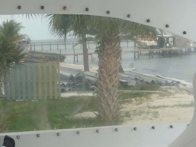 Slide: The Image of View from 1985 Wellcraft Scarab 34, overlooking palm tree and waterfront dock. - 22