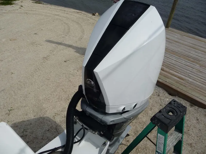 Slide: The Image of 1985 Wellcraft Scarab 34 outboard motor on sandy shore. - 25