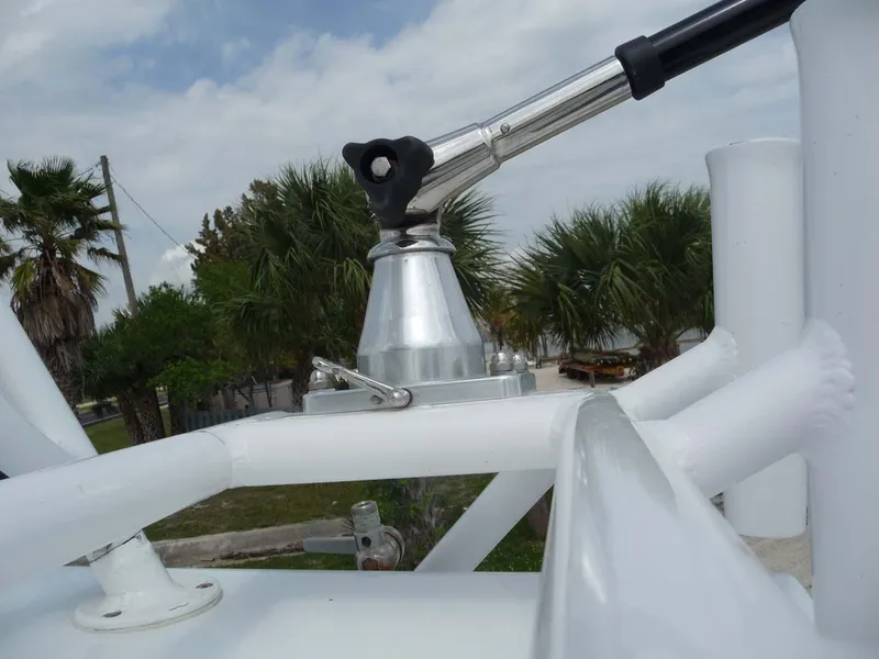 Slide: The Image of Close-up of 1985 Wellcraft Scarab 34 boat structure with palm trees in background. - 28