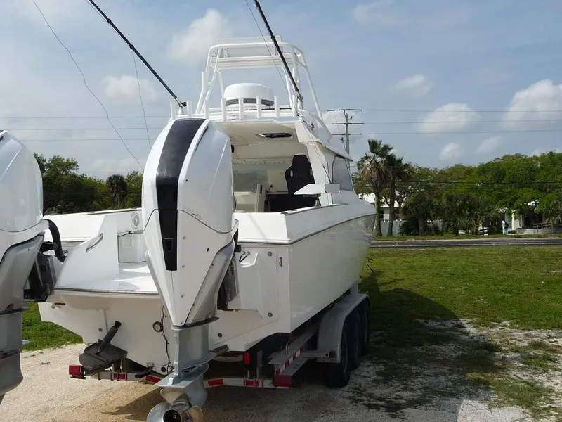 Slide: The Image of 1985 Wellcraft Scarab 34 boat on trailer with dual outboard motors. - 4