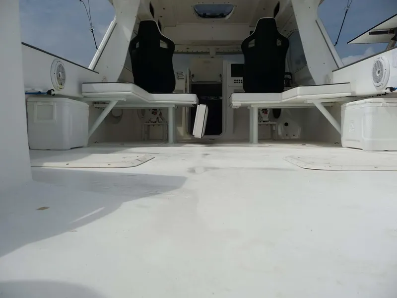 Slide: The Image of 1985 Wellcraft Scarab 34 interior with white seating and spacious deck. - 8