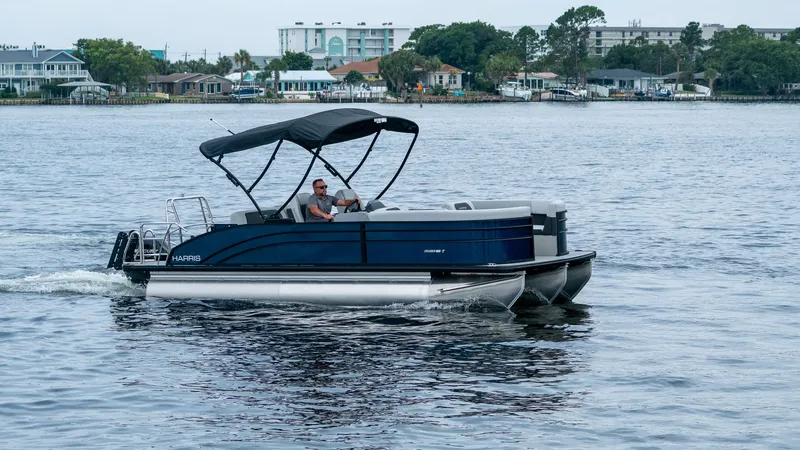 Slide: The Image of Harris Cruiser 230 pontoon boat 2026 on calm water. - 0