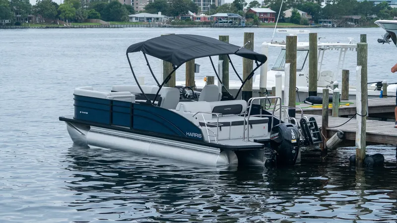Slide: The Image of 2026 Harris Cruiser 230 pontoon boat docked. - 9