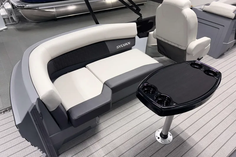 Slide: The Image of 2026 Sylvan R 20 LZ DH boat interior with seating and table, showcasing modern design. - 14