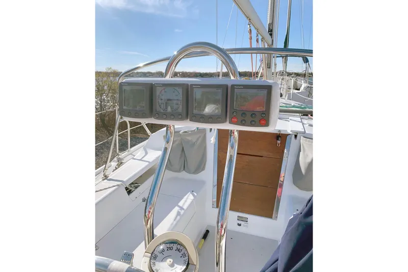 The Image of Cockpit of 2006 Catalina 28 sailboat with navigation instruments and steering wheel. - 0