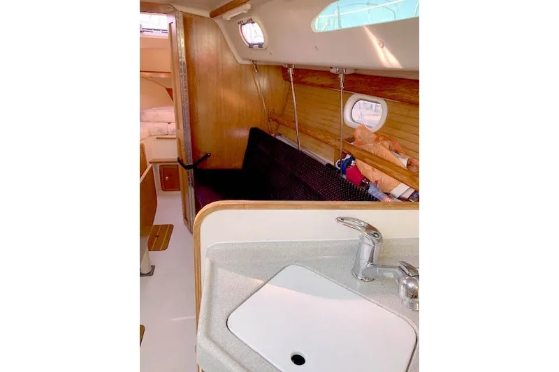Slide: The Image of Interior of 2006 Catalina 28 sailboat with sink and cozy cabin area. - 5