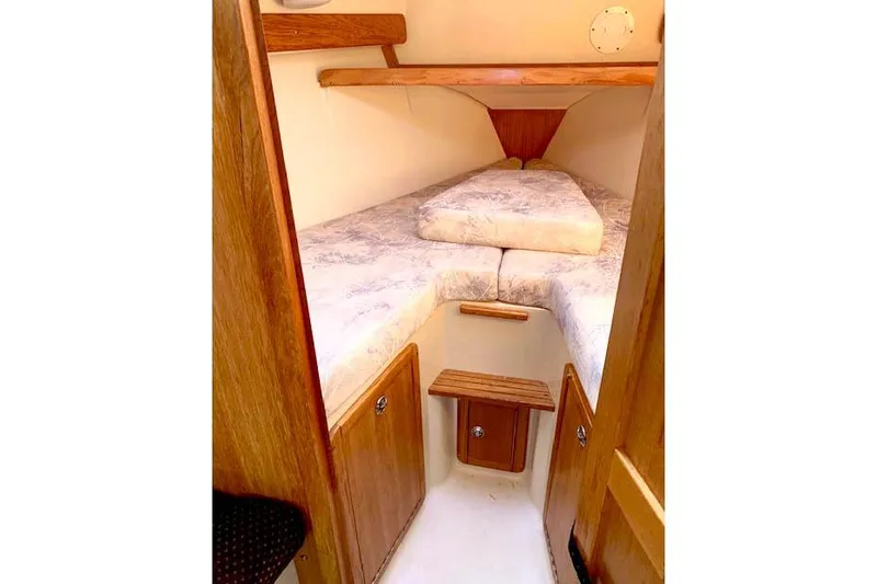 Slide: The Image of Cozy cabin interior of a 2006 Catalina 28 sailboat with wooden accents. - 8