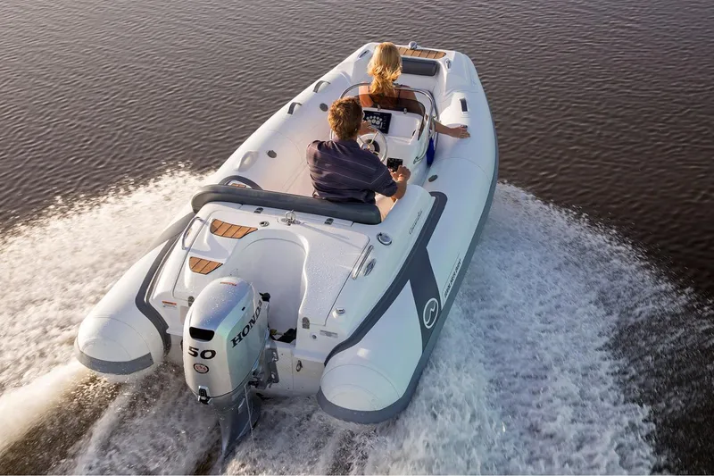 Slide: The Image of Manufacturer Provided Image: 2024 Walker Bay Generation 400 DLX inflatable boat cruising on water. - 2