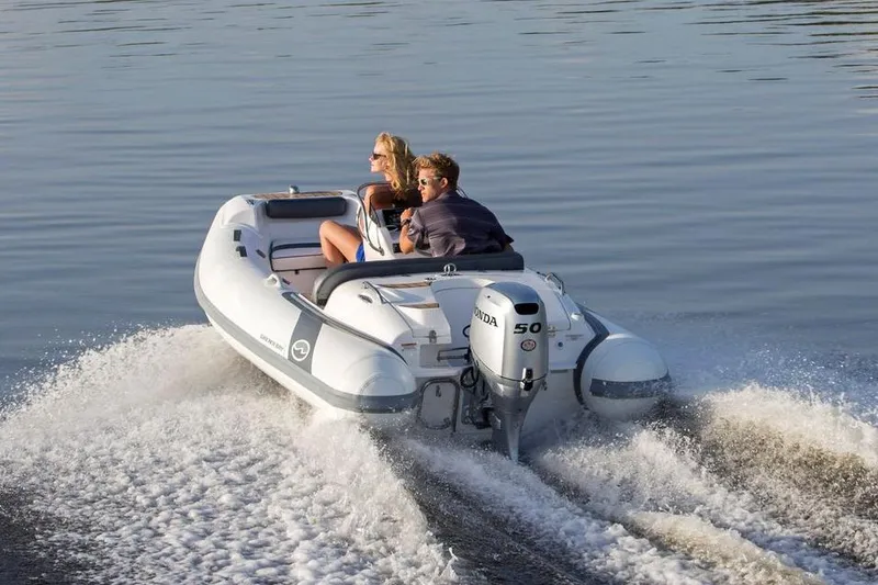 Slide: The Image of Manufacturer Provided Image: 2024 Walker Bay Generation 400 DLX inflatable boat cruising on water. - 4