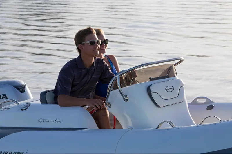 Slide: The Image of Manufacturer Provided Image: 2024 Walker Bay Generation 400 DLX boat with two people cruising on water. - 7