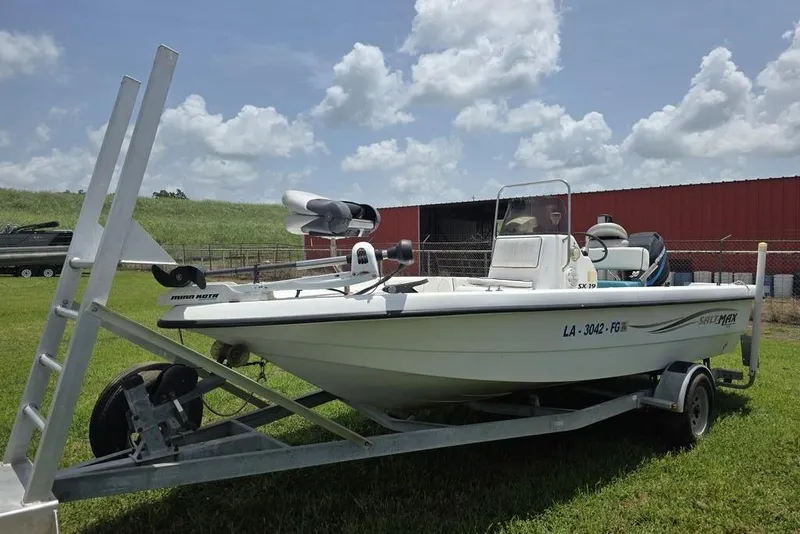 Slide: The Image of 2002 Sprint Salt-Max boat on trailer, parked on grass under a cloudy sky. - 4