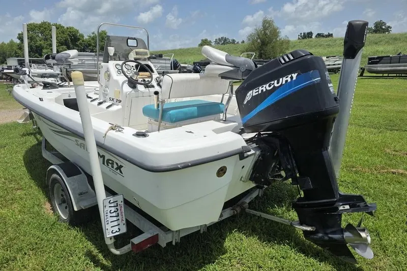 Slide: The Image of 2002 Sprint Salt-Max boat with Mercury outboard motor on a trailer, parked on grass. - 5