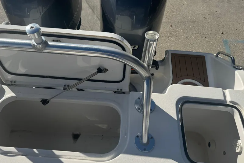 Slide: The Image of 2022 Sea Hunt Gamefish 25 boat interior with open storage compartments and dual engines. - 13