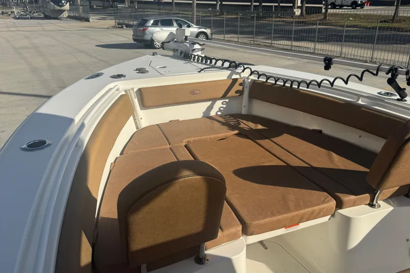 Slide: The Image of 2022 Sea Hunt Gamefish 25 boat with tan cushioned seating in the bow area. - 19