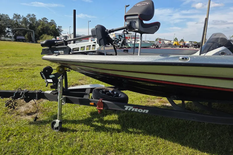 Slide: The Image of 2021 Triton 20 TrX boat on trailer with Mercury Pro XS engine, parked on grass. - 5