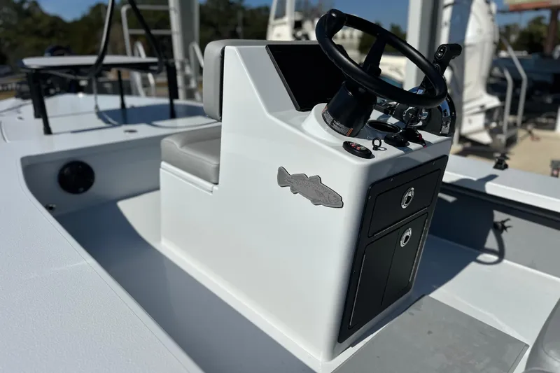 Slide: The Image of 2025 East Cape VHP boat console with steering wheel and storage compartments. - 10