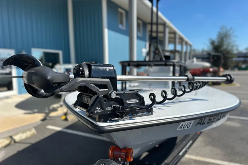 Slide: The Image of 2025 East Cape VHP boat with Power-Pole trolling motor, parked outside a blue building. - 12