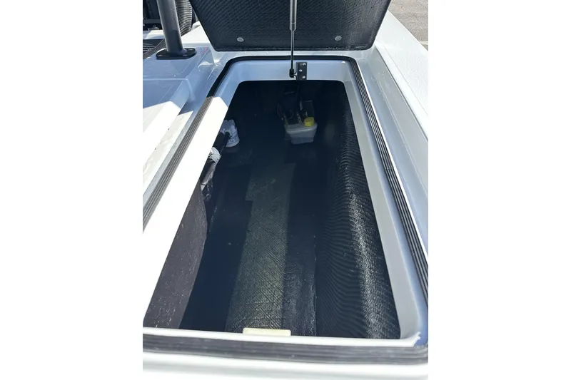 Slide: The Image of 2025 East Cape VHP boat storage compartment with open lid, showcasing interior space. - 25