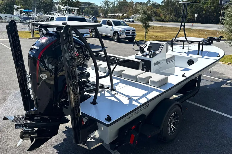 Slide: The Image of 2025 East Cape VHP boat with powerful outboard motor, parked on a trailer. - 27