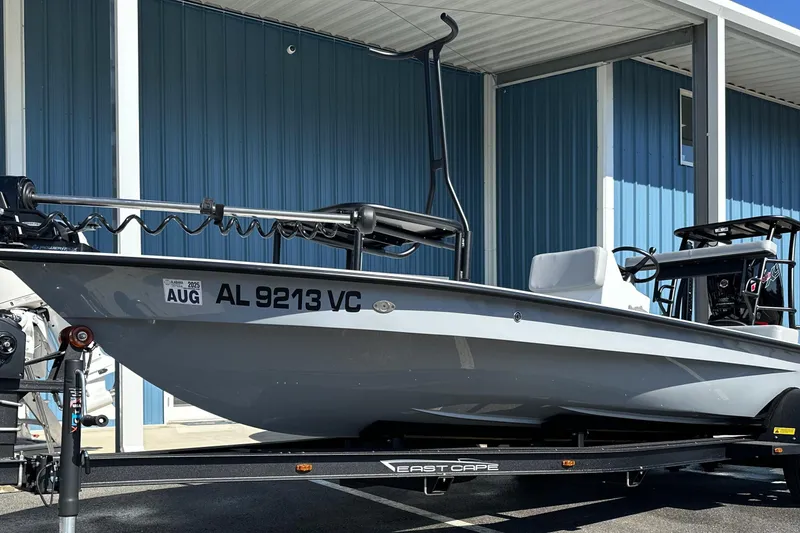 Slide: The Image of 2025 East Cape VHP boat on trailer, parked near blue building. - 4