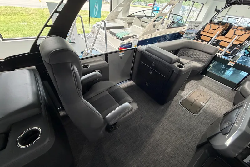 Slide: The Image of Luxurious interior of 2026 Godfrey Monaco 235ULC pontoon boat with plush seating and table. - 15