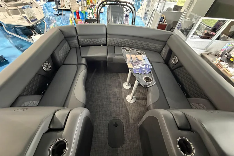 Slide: The Image of Captain's seat and helm of 2026 Godfrey Monaco 235ULC boat, showcasing modern design and controls. - 16