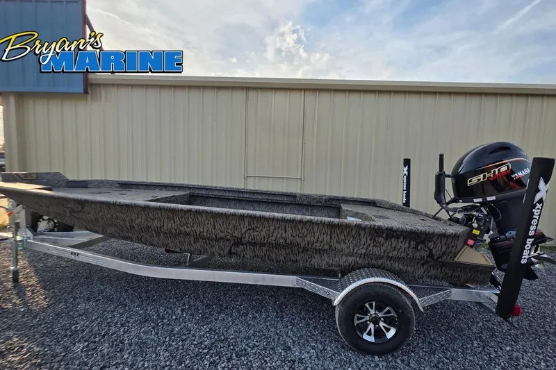 The Image of 2026 Xpress X18DB boat on trailer at Bryan's Marine dealership. - 1