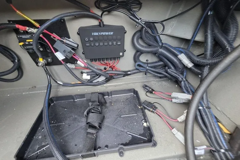 Slide: The Image of Open battery compartment of 2026 Xpress X18DB boat with wiring and components. - 16