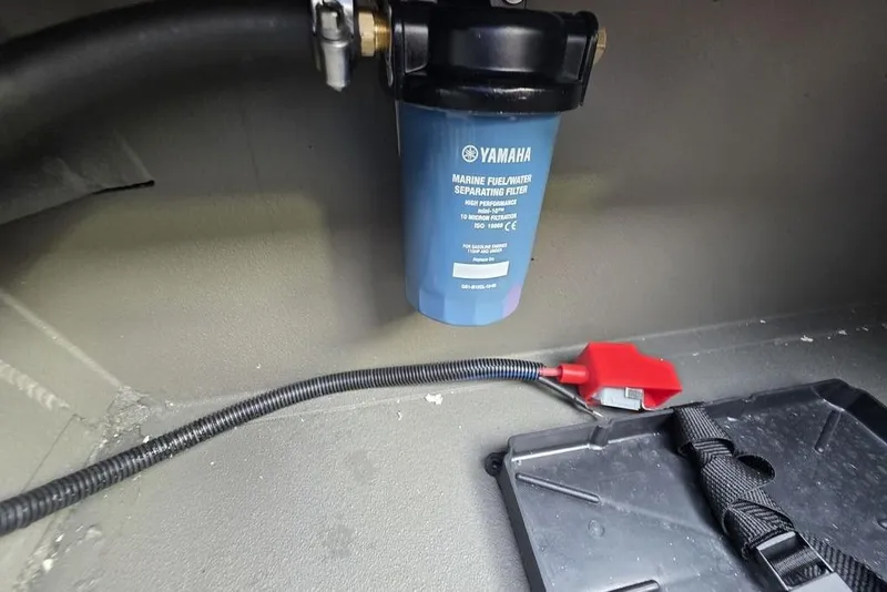 Slide: The Image of Tangled cables and connectors inside a 2026 Xpress X18DB boat. - 18