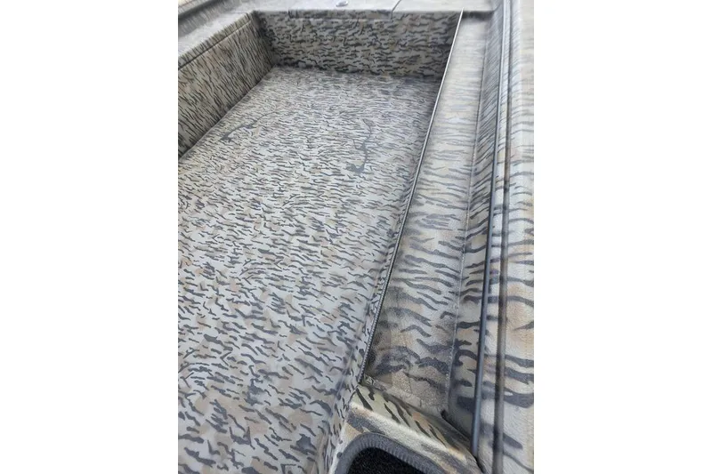 Slide: The Image of 2026 Xpress X18DB boat with camo design, featuring spacious interior and modern controls. - 21