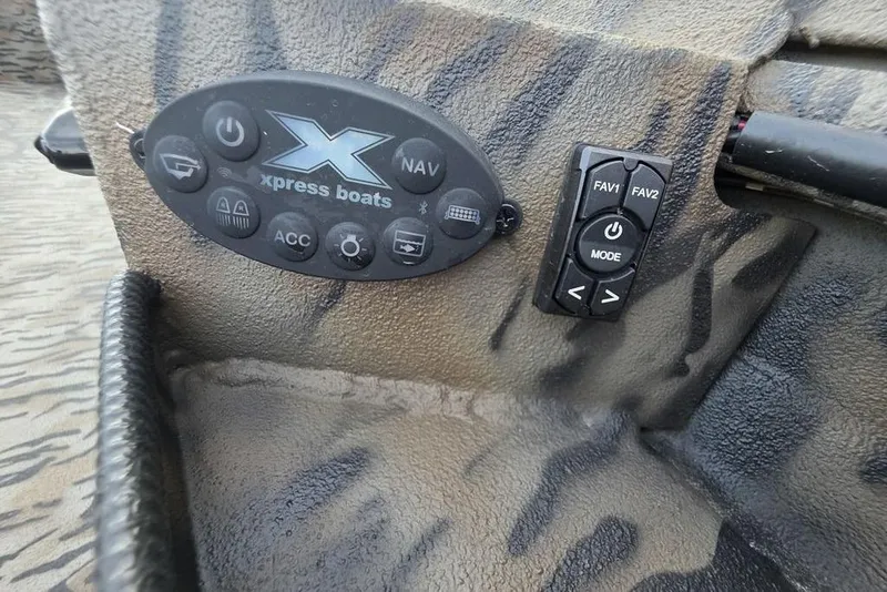 Slide: The Image of 2026 Xpress X18DB boat deck with camouflage pattern and storage compartments. - 23