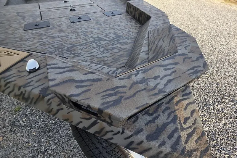 Slide: The Image of Camouflage-patterned Xpress X18DB 2026 boat console with cup holder and storage compartment. - 26