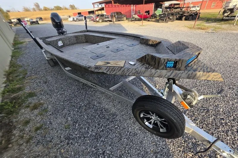 Slide: The Image of 2026 Xpress X18DB boat interior with camo pattern and built-in storage compartment. - 31