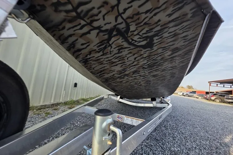 Slide: The Image of Open storage compartment in 2026 Xpress X18DB boat, showing interior details. - 32