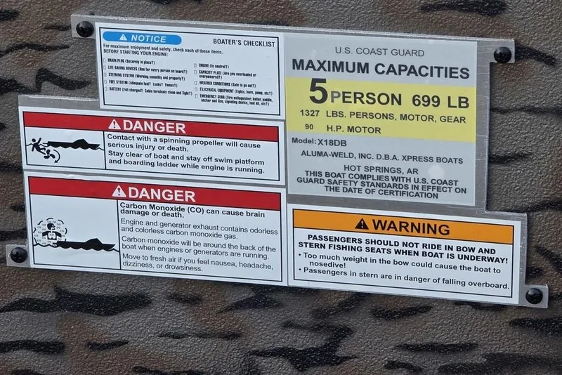 Slide: The Image of 2026 Xpress X18DB boat with camouflage design on a trailer, parked outdoors. - 33