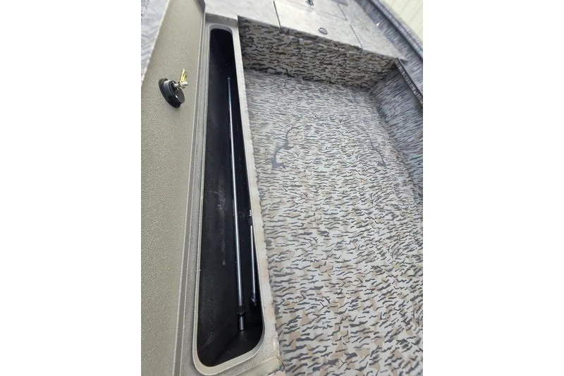 Slide: The Image of 2026 Xpress X18DB boat interior with camouflage flooring and storage compartment. - 36
