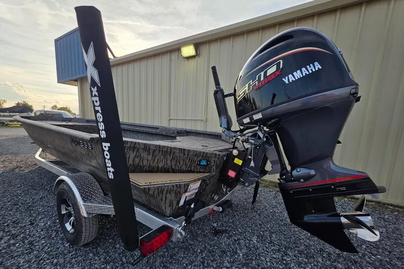 Slide: The Image of 2026 Xpress X18DB boat on trailer at Bryan's Marine dealership. - 4