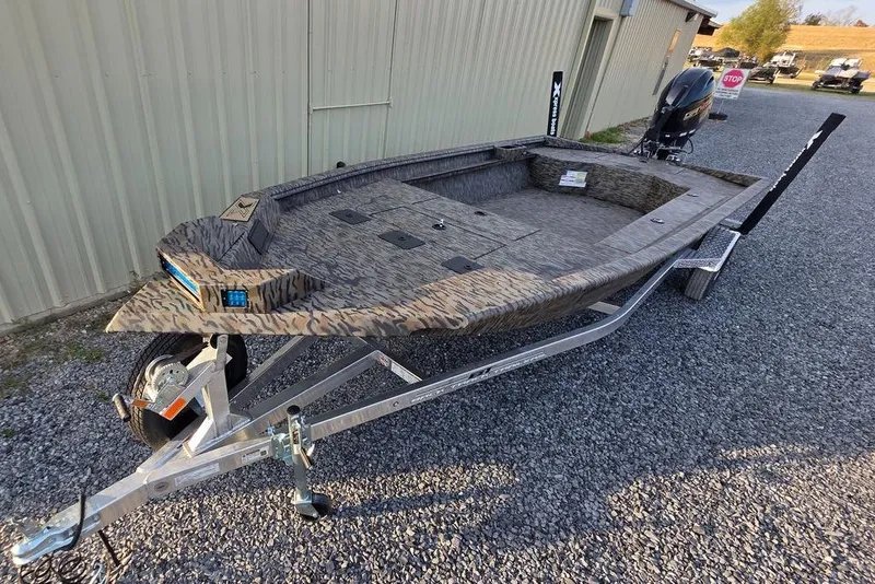 Slide: The Image of 2026 Xpress X18DB boat with Yamaha engine, parked on gravel lot. - 6