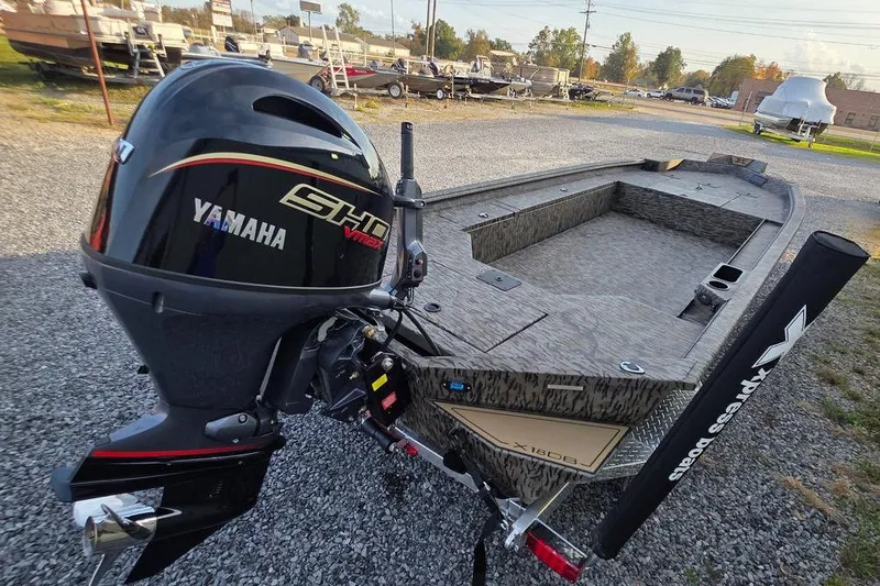 Slide: The Image of 2026 Xpress X18DB boat with Yamaha SHO VMAX engine, parked on gravel. - 7