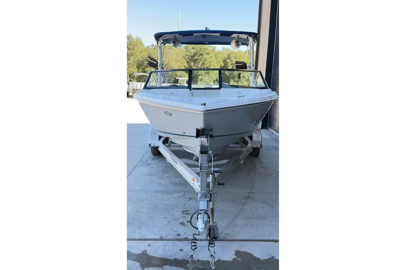 Slide: The Image of 2020 Cobalt CS23 Surf boat on trailer, parked outdoors. - 11