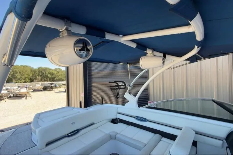 Slide: The Image of 2020 Cobalt CS23 Surf boat interior with speakers and blue canopy. - 6