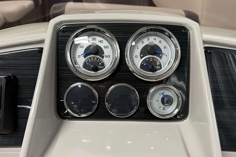 Slide: The Image of Dashboard of 2026 Sylvan Mirage 820 Cruise with speedometer and fuel gauges. - 11