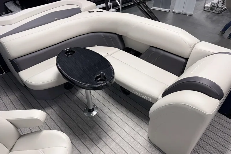 Slide: The Image of Luxurious seating area on 2026 Sylvan Mirage 820 Cruise pontoon boat with sleek table design. - 13