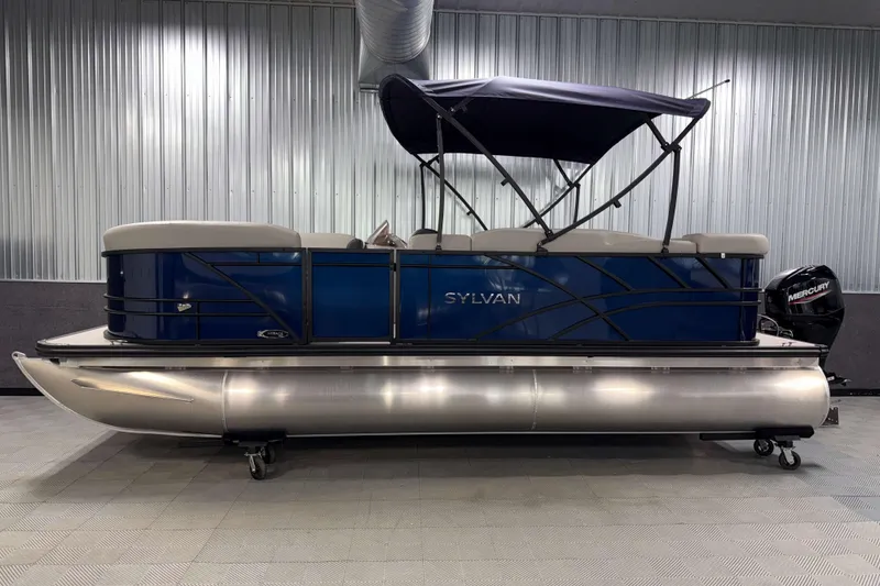 Slide: The Image of 2026 Sylvan Mirage 820 Cruise pontoon boat in a showroom with a Mercury engine. - 19